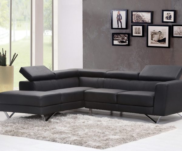 Contemporary living room featuring a sleek black sectional sofa and chic wall art.